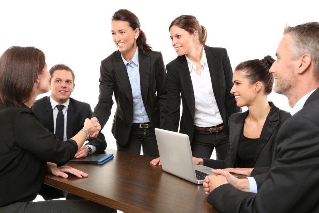 people in a stock photo discussing a business idea
